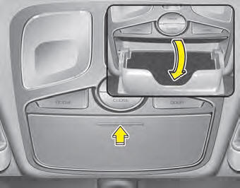 To open the sunglass holder, press the cover and the holder will slowly open.