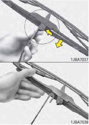 2. Compress the clip and slide the blade assembly downward.