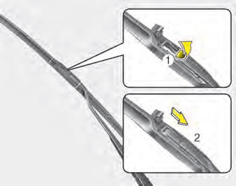 2. Lift up the wiper blade clip. Then pull down the blade assembly and remove